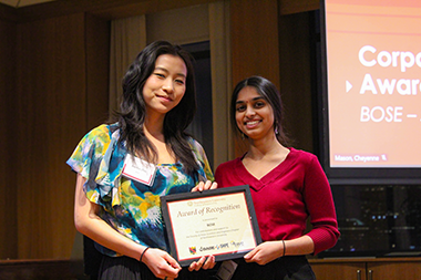 BOSE representative standing with a student holding an award