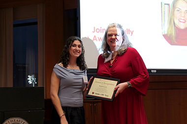 marybeth savicki holding an award and standing next to a student